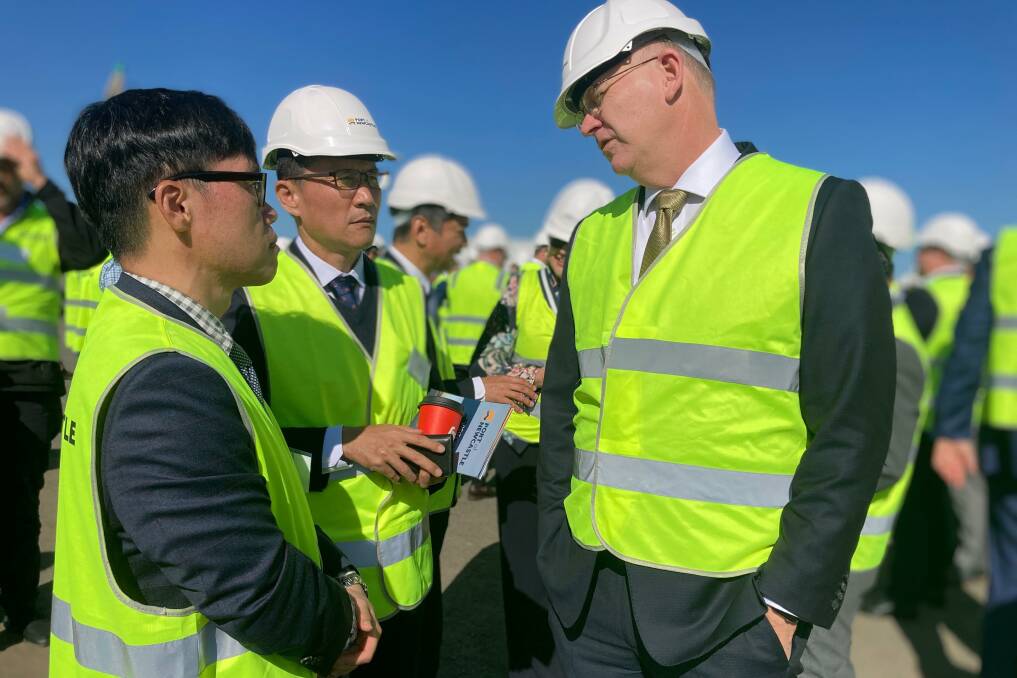 Port of Newcastle chief executive Craig Carmody talking to KEPCO executives Chun Chan-hyuk and Kim Jong-sung at the media conference on Wednesday. Picture by Michael Parris