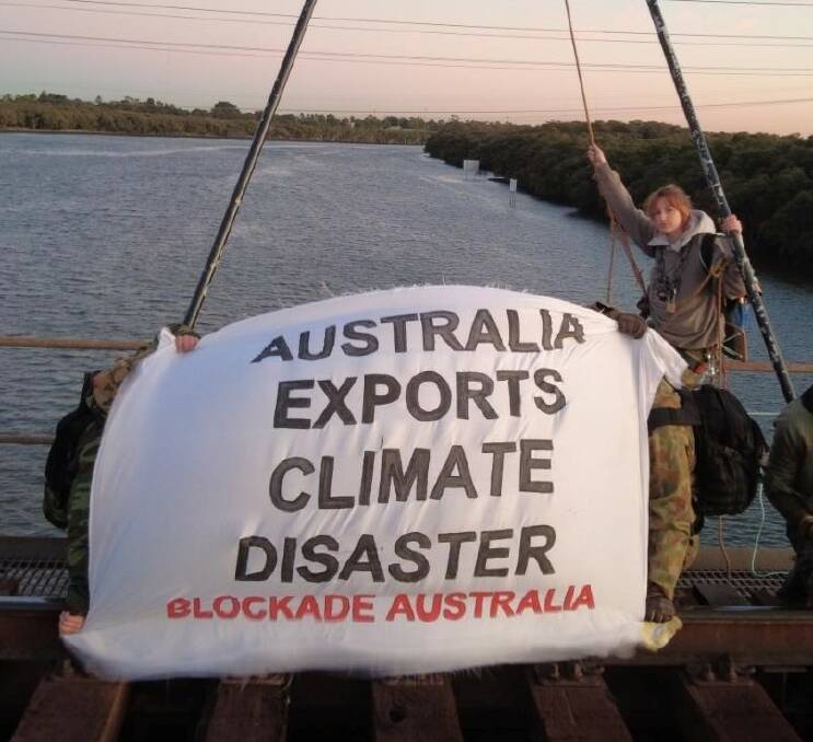Blockade Australia activist Raffi positioned herself with a 'bipod' and ropes at Kooragang.