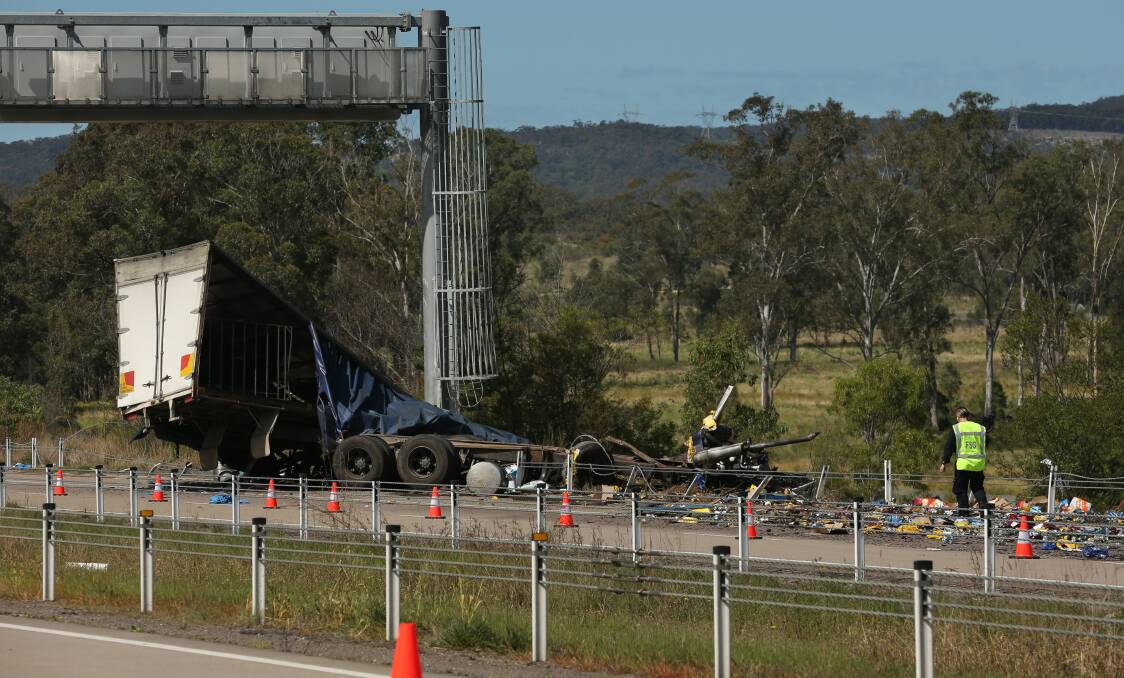 SCENE: The beer truck crashed on the Hunter Expressway near the John Renshaw Drive exit about 7am on Monday. There was debris from the incident strewn for along 50 metres of the road. Picture: Simone De Peak