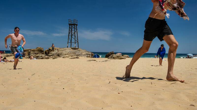 Running to get across the hot sand at Redhead Beach. Picture: Marina Neil