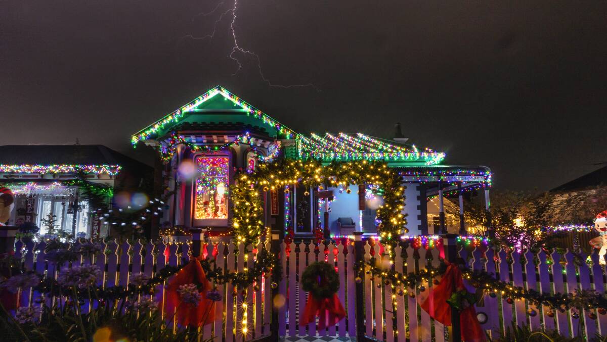 Lightning over 'Lilibet's' Christmas light display on Elizabeth Street, Mayfield. Picture by Marina Neil