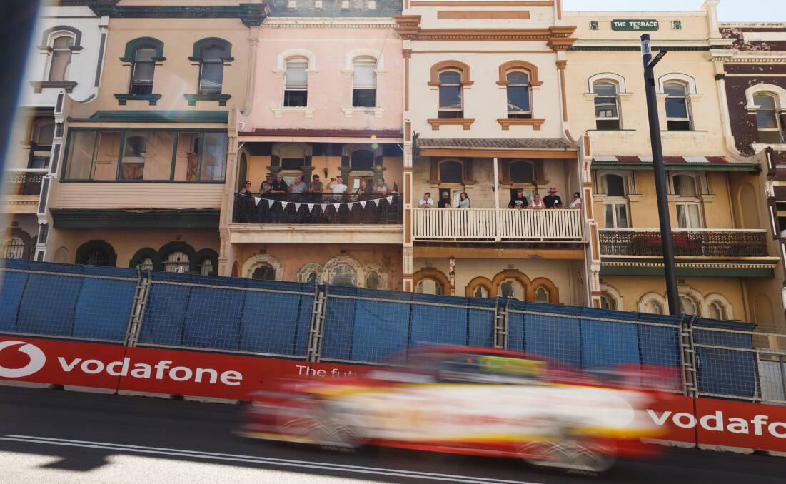 APPLICATION: A race car speeds past historic terraces in Watt Street. Supercars' return to Newcastle in 2023 is contingent on approval from Heritage NSW and two other government agencies.