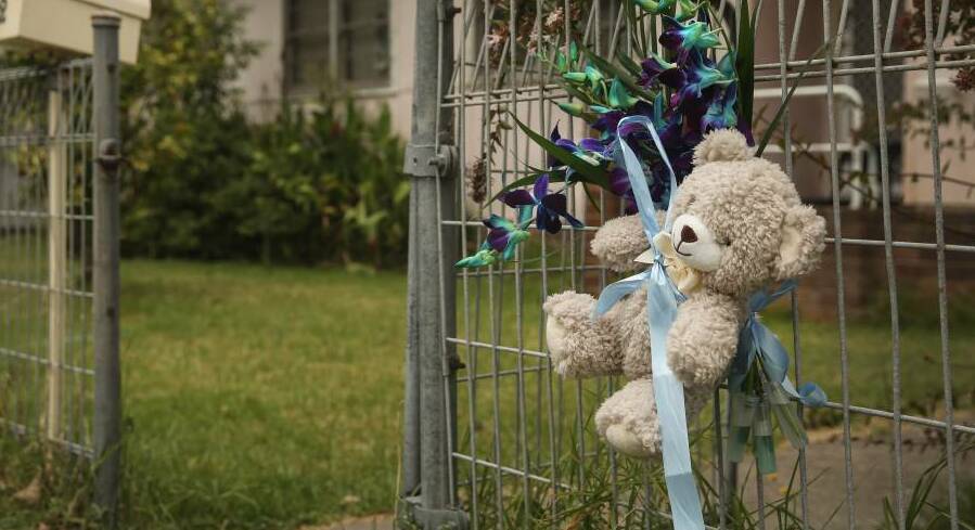 TRAGEDY: Tributes to the baby boy were tied to the fence of the New Lambton home where he was staying before he died. Picture: MARINA NEIL
