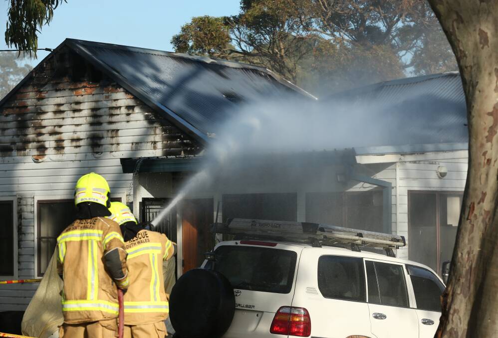 AFTERMATH: Firefighters at the scene of a house fire in Meredith Street, Kotara on Monday. Picture: Simone De Peak