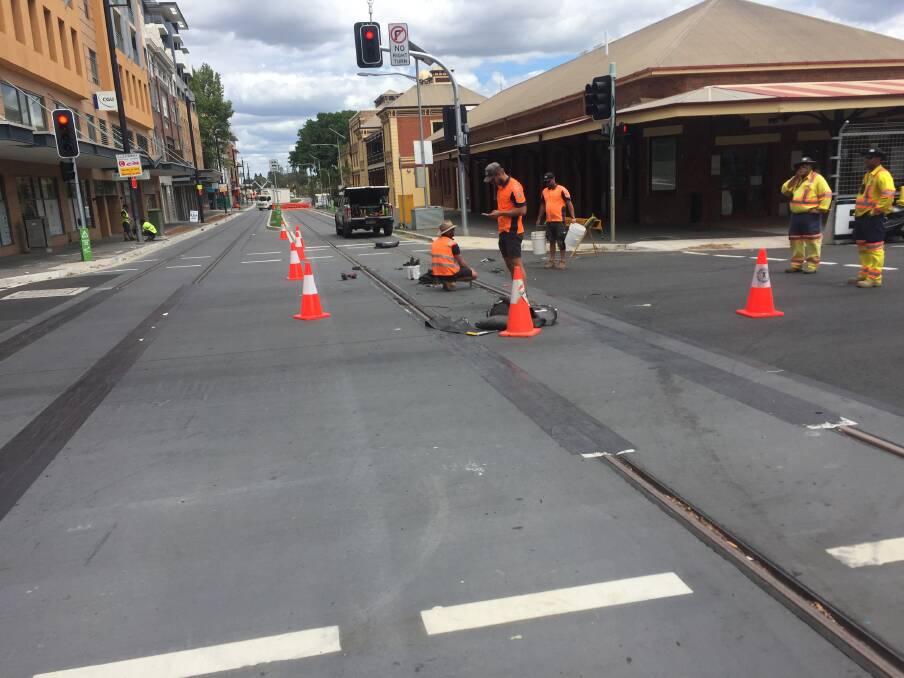 SUPERCARS: Crews work to remove the light rail covers. Picture: Max McKinney