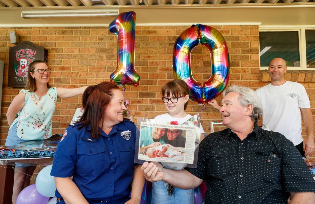 SMILES: Paramedics Erin Laughton and Mark Wilson meet Bralie Wilson on her 10th birthday. Pictured at home with her parents Kristy and Gavin Wilson. Picture Max Mason-Hubers