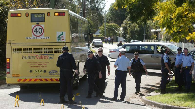 Police at Mount Hall Road Raymond Terrace where a teenager was struck by a school bus and killed. Pictures: Simone De Peak