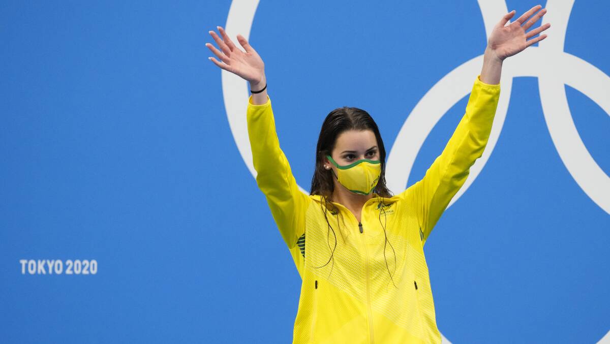 Kaylee McKeown waves from the medal podium after winning the final of the women's 100m backstroke. Picture: AP