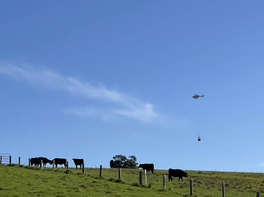 HELP FROM THE AIR: The hay helicopter on its way to a drop at Hinton. 