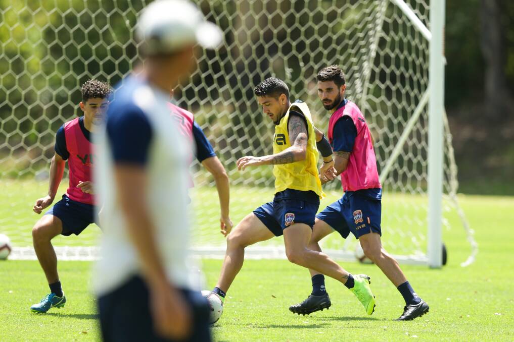 PRACTICE MAKES PERFECT: Jets coach Ernie Merrick casts a watchful eye over Dimi Petratos at training. Picture: Jonathan Carroll