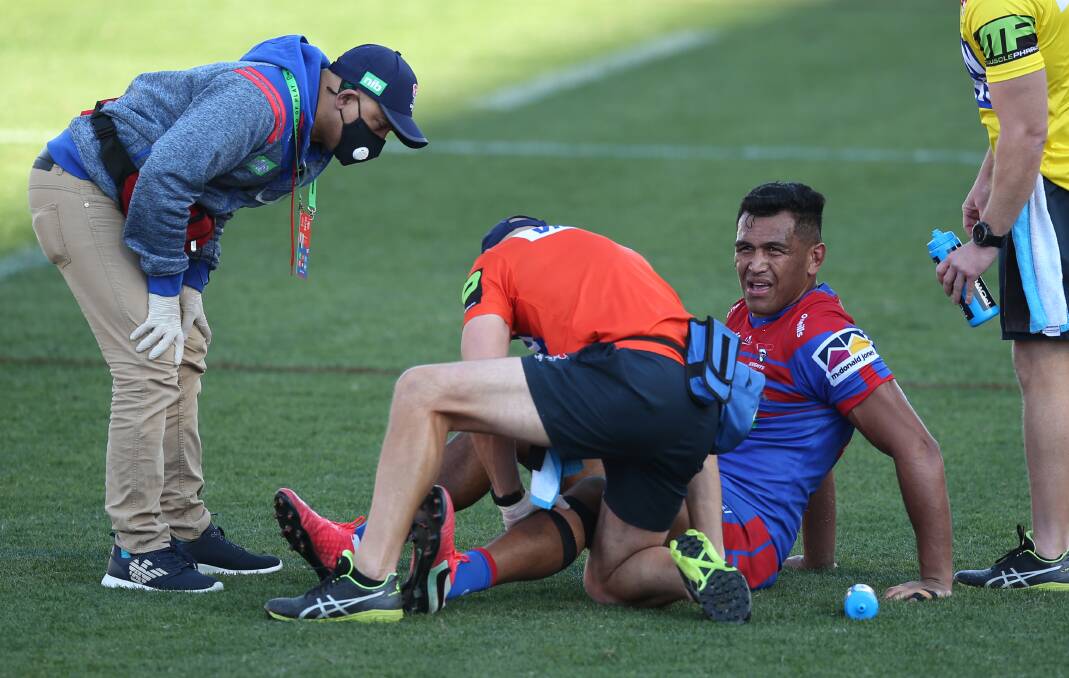 BODY BLOW: Newcastle prop Daniel Saifiti receives treatment after re-injuring his knee in last week's win against Manly. Picture: Simone De Peak