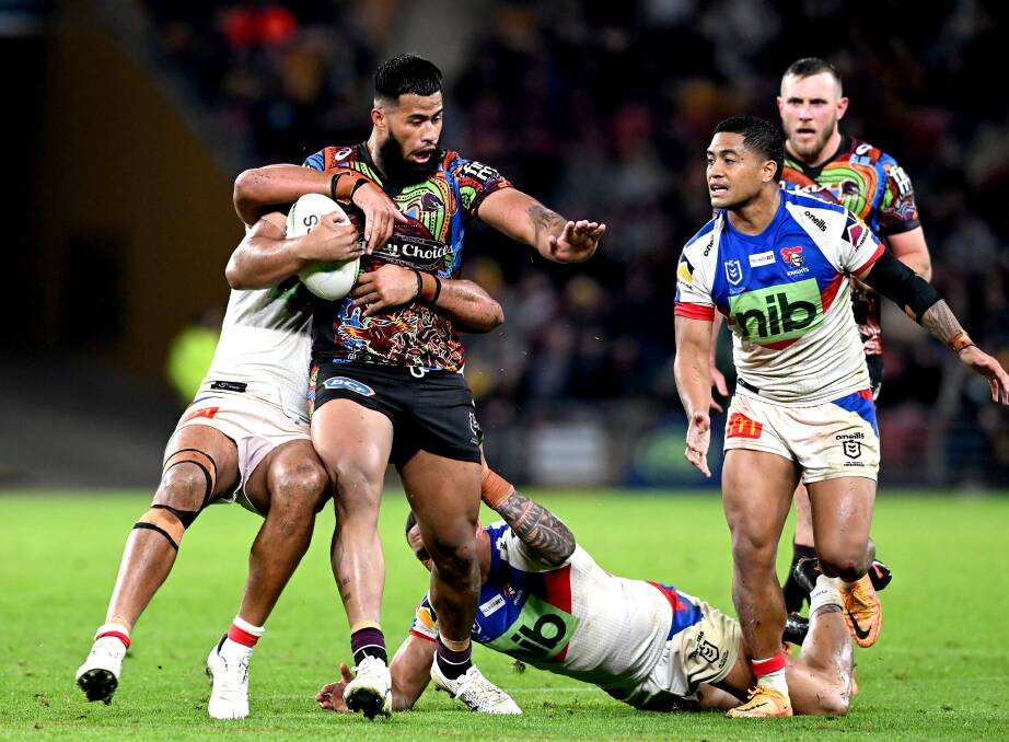 POWER GAME: Newcastle players struggle to bring down Brisbane prop Payne Haas at Suncorp Stadium on Saturday night. Picture: Getty Images