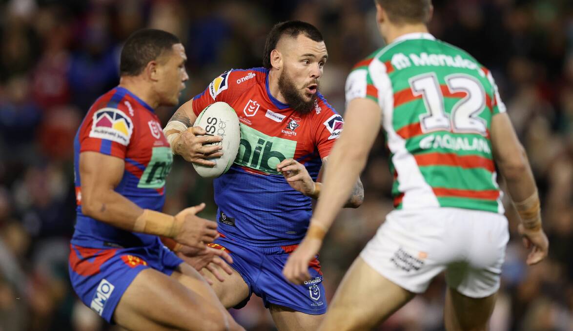 HARD YARDS: Knights prop
David Klemmer takes a hit-up
against South Sydney.
Picture: GETTY IMAGES