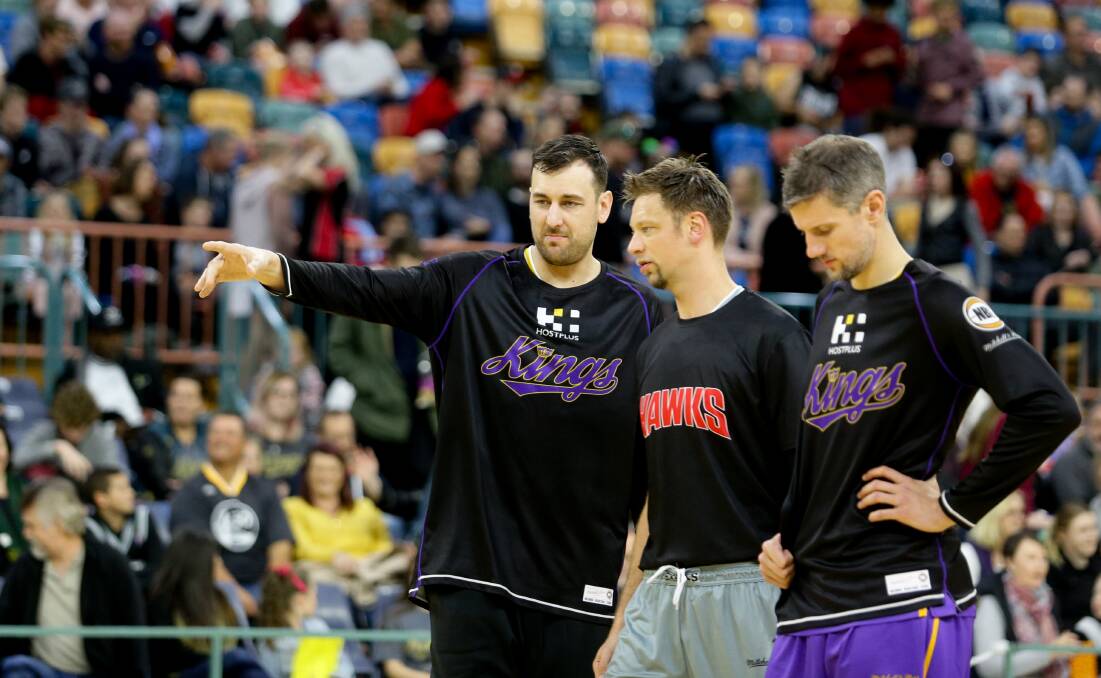 FIASCO: Andrew Bogut and other players discuss the playing surface at Newcastle Entertainment Centre before the game was abandoned. Picture: Jonathan Carroll