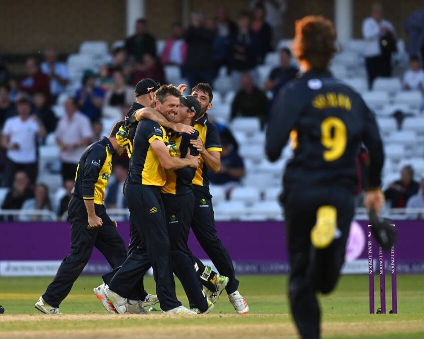 HOW SWEET IT IS: Glamorgan players mob Michael Hogan after claiming the last wicket in their Royal London Cup final victory against Durham. Picture: Getty Images