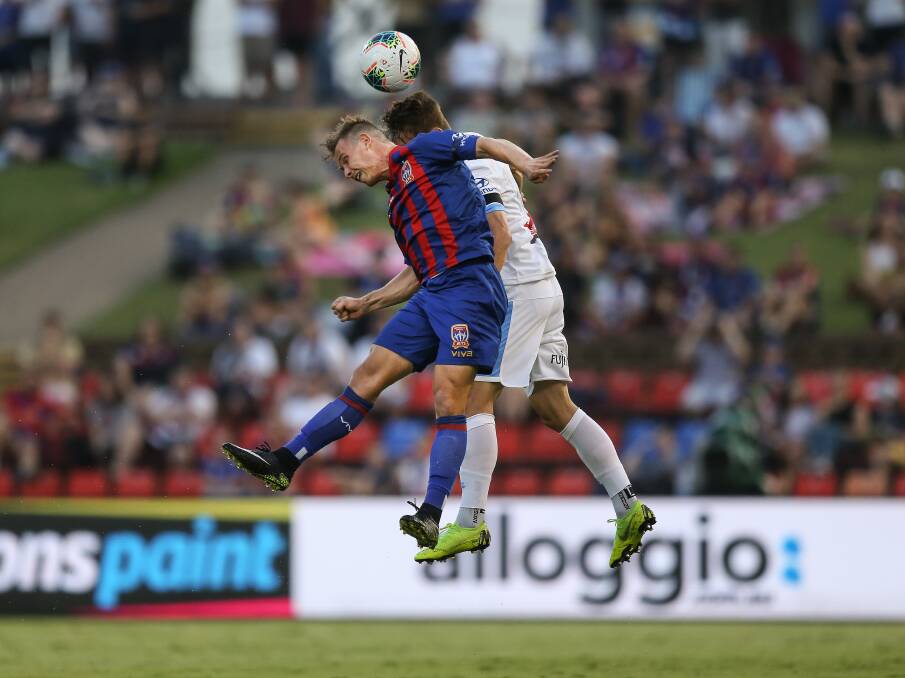 HIGH FLYERS: Newcastle's Nick Fitzgerald launches himself to win a header against Sydney last friday. Picture: Marina Neil 