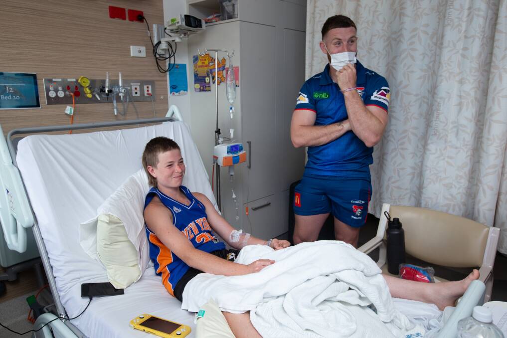 Jackson Hastings spends time with young Aiden Jennings at John Hinter Hospital. Picture by Jonathan Carroll 