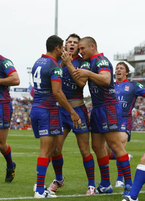 YOU BEAUTY: Knights players congratulate James McManus after his first try in the NRL, in 2007. Picture: Darren Pateman