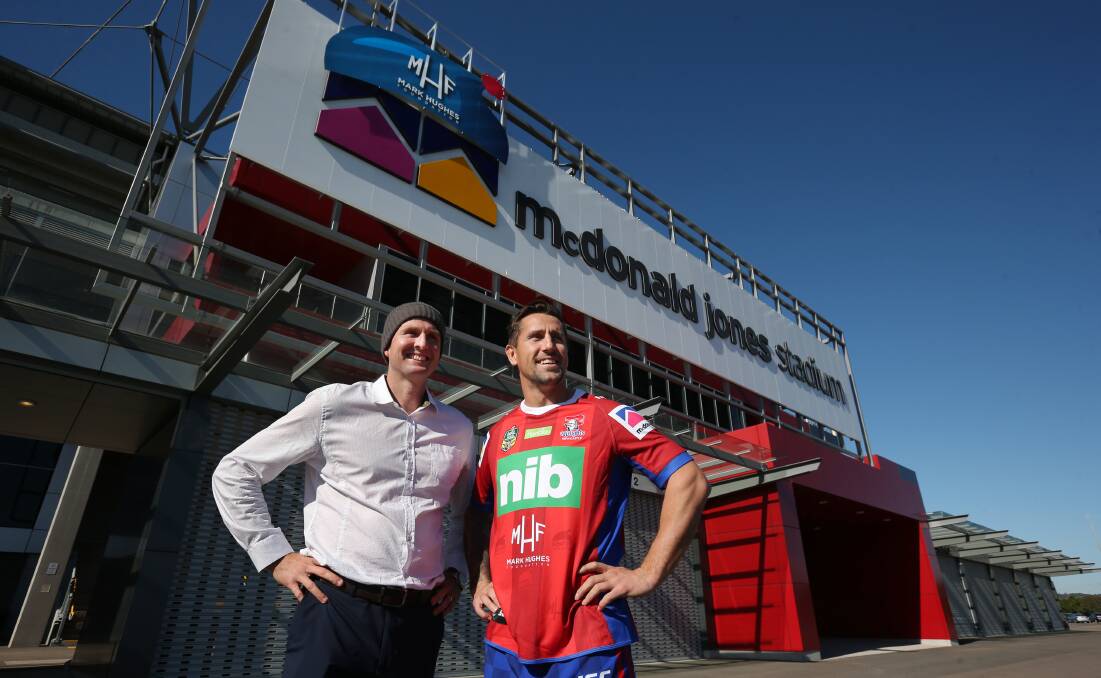 GOOD CAUSE: Mark Hughes and Knights skipper Mitchell Pearce (wearing a commemorative jersey) outside what will be known as Beanies For Brain Cancer Stadium this weekend. Picture: Simone De Peak
