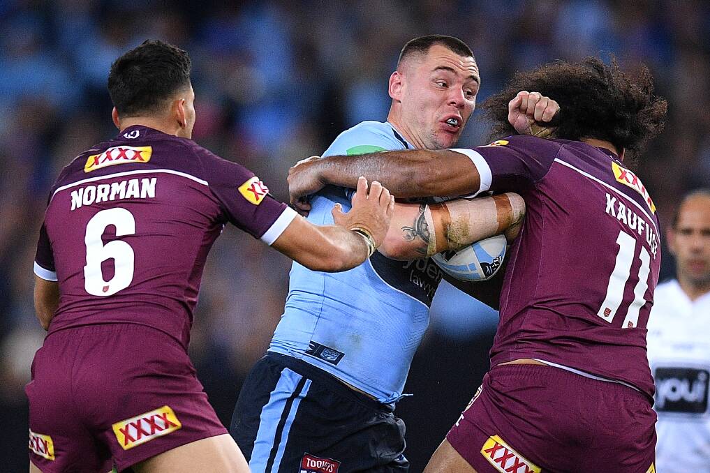 CRASH: NSW prop David Klemmer
charges into the Queensland defence
on Wednesday night. Picture: AAP