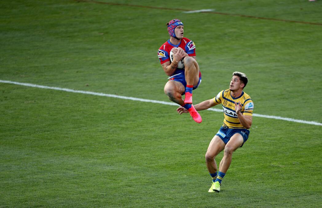 HIGH CLASS: Kalyn Ponga soars above Dylan Brown to catch a bomb. Picture: NRL Photos
