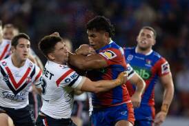 Roosters lock Victor Radley crunches Newcastle's Jacob Saifiti. Picture by Jonathan Carroll 