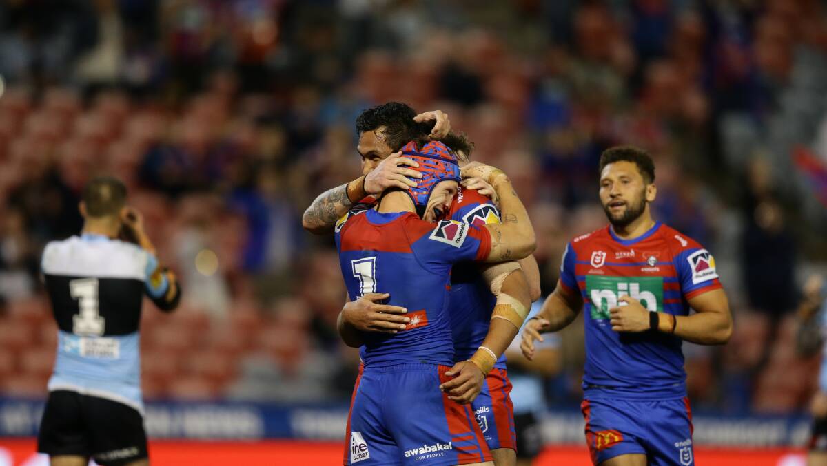 YOU BEAUTY: The Knights congratulate Kalyn Ponga after scoring his third try against Cronulla. Picture: Jonathan Carroll