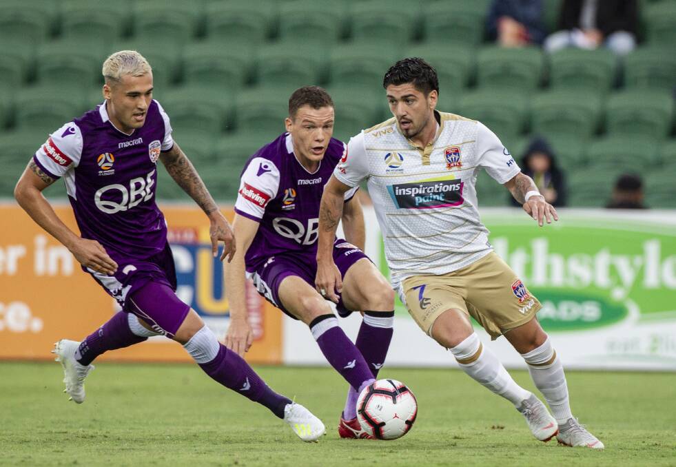 ON THE BALL: Newcastle playmaker Dimi Petratos looks for supporting teammates in Sunday night's clash with Perth Glory at HBF Stadium. Picture: Tony McDonough, AAP