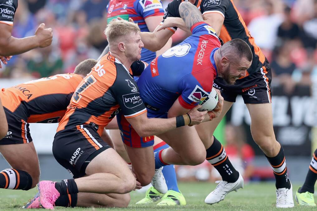 WRAPPED UP: Knights prop David Klemmer runs into heavy traffic in Sunday's clash with the Tigers. Picture: Getty Images