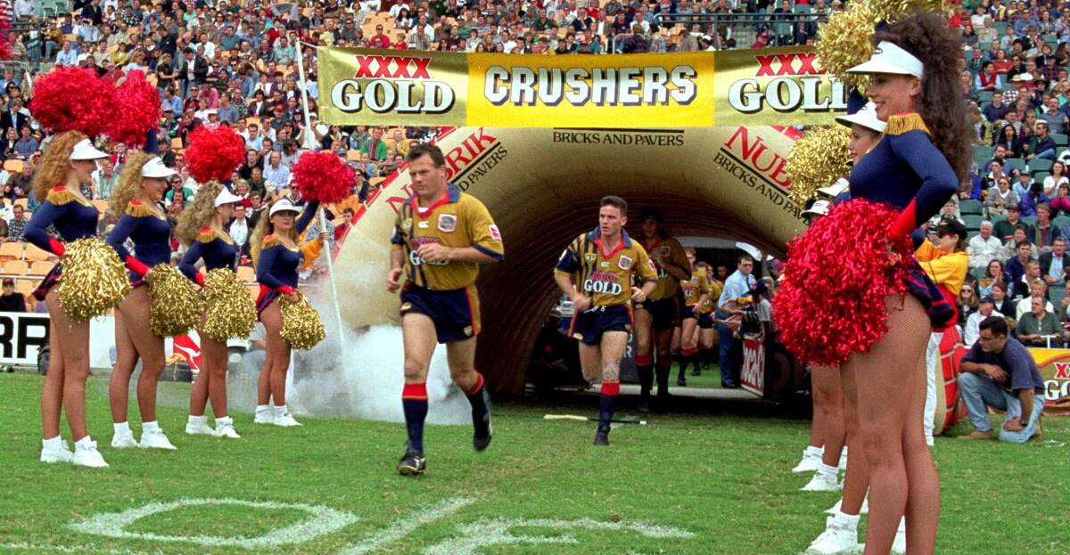 FLASHBACK: Trevor Gillmeister leads out the South Queensland Crushers for a game in 1996. They folded after three disappointing seasons. Picture: Getty Images