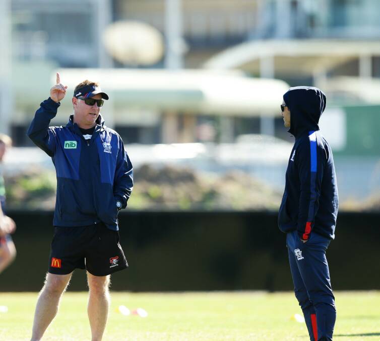 PRESSURE POINT: Knight coach Adam O'Brien and club legend Andrew Johns talk tactics at training on Wednesday. Picture: Jonathan Carroll