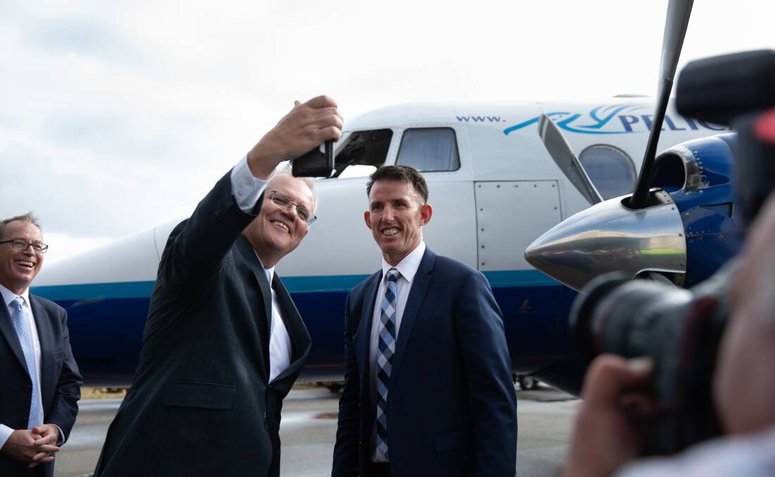 HIGH FLYERS: Starstruck Prime Minister Scotty from Marketing grabs a selfie with Knights legend Steve Crowe at Newcastle Airport last week. Picture: Marina Neil
