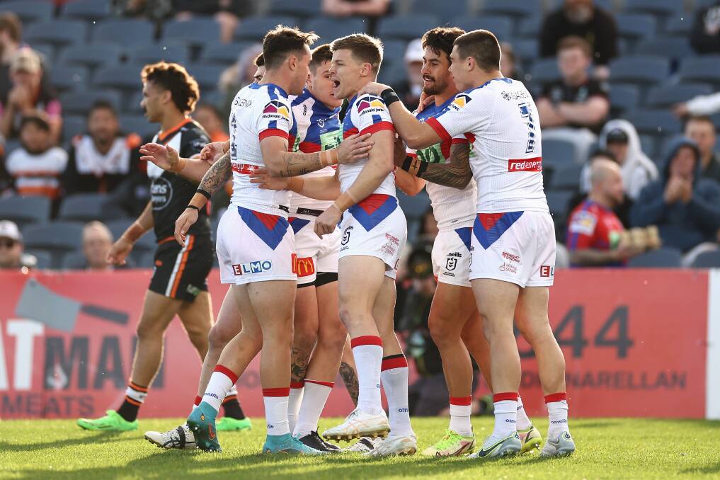 YOU BEAUTY: The Knights celebrate an early try against the Tigers on Sunday. Picture: Getty Images