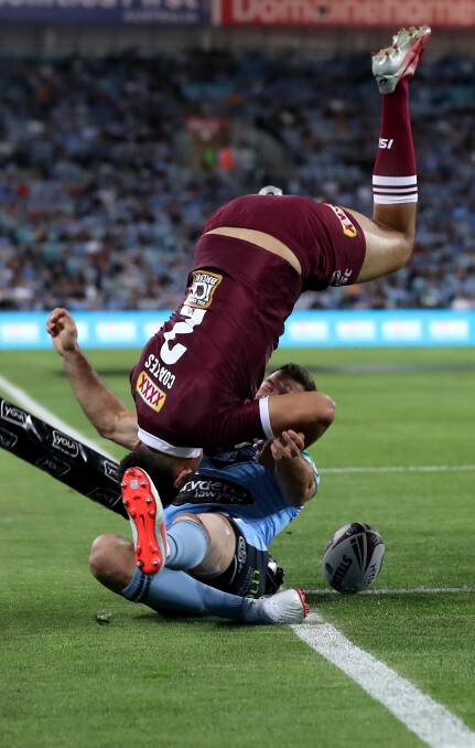 HANG TIME: Queensland winger Xavier Coates scores a spectacular try, despite the desperate defence of James Tedesco. Picture: Mark Kolbe/Getty Images
