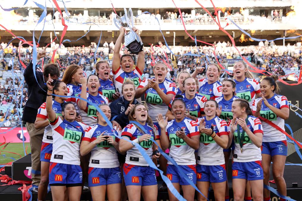 Newcastle players with the NRLW premiership trophy after their 32-12 triumph against Parramatta. Picture Getty Images