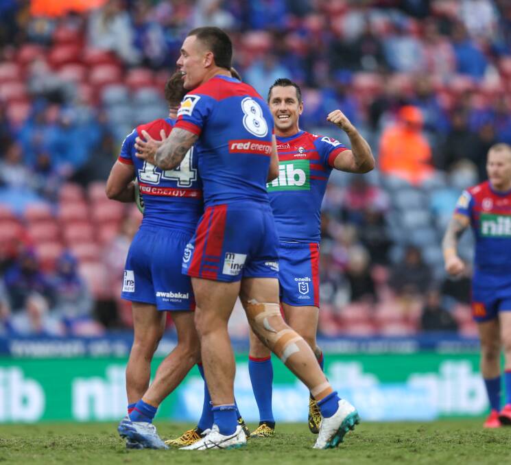 HOW SWEET IT IS: David Klemmer and Mitchell Pearce congratulate Connor Watson at full-time on Saturday. Picture: Marina Neil