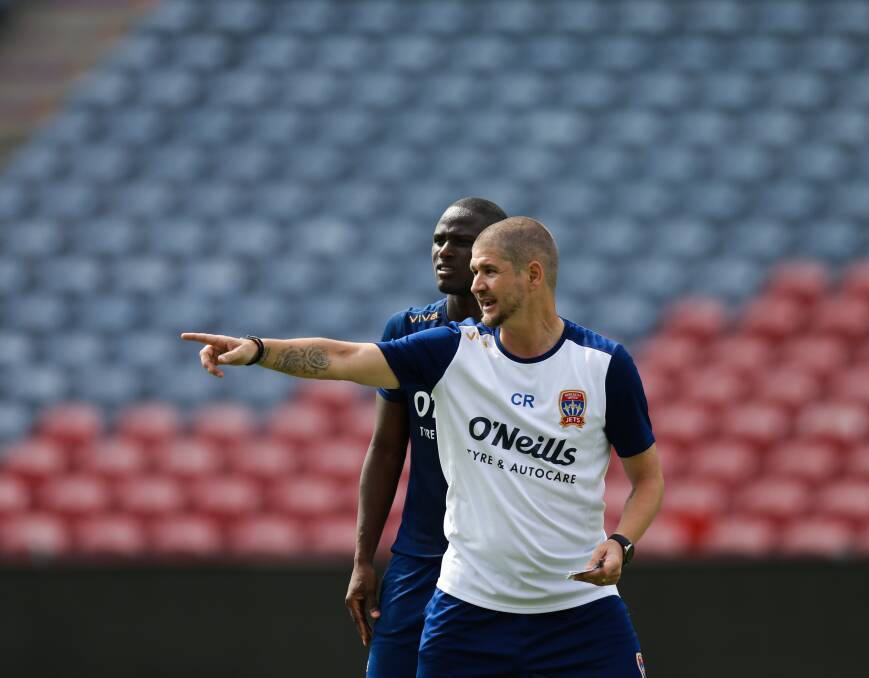 MAKING A POINT: Jets coach Carl Robinson issues instructions to Abdiel Arroyo at training. Picture: Jonathan Carroll