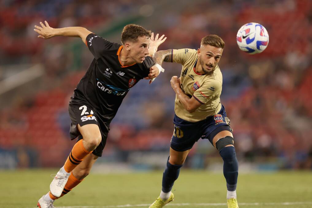 Brisbane's Kai Trewin and Newcastle's Reno Piscopo battle it out at McDonald Jones Stadium on Friday. Picture by Getty Images
