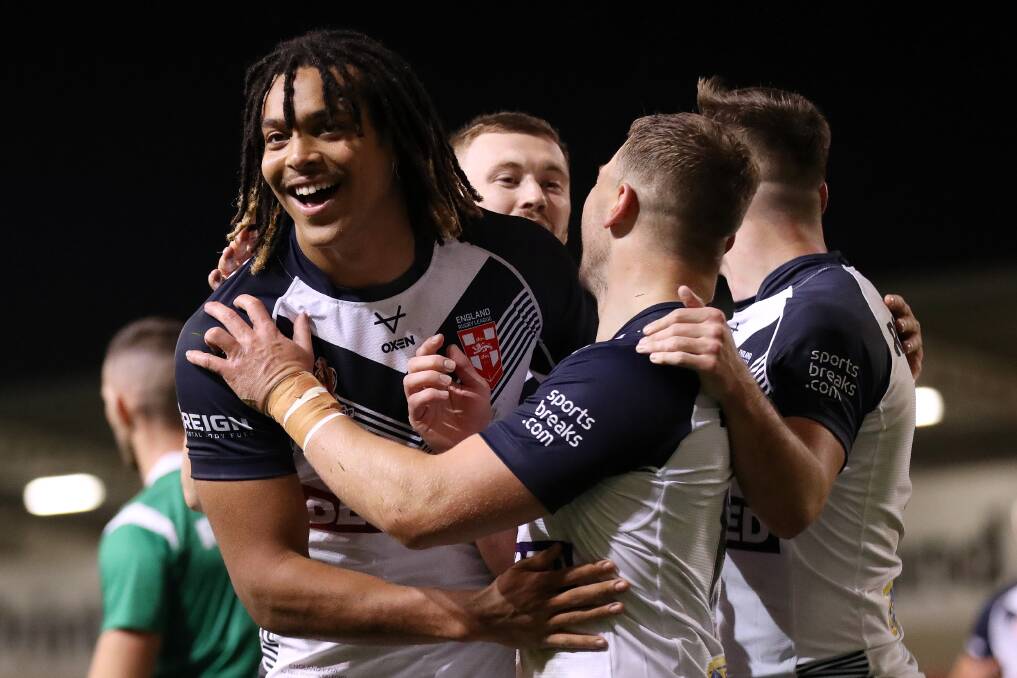 England players congratulate Dominic Young after the towering winger scored a try on his international debut in the 50-0 demolition of Fiji at Salford on Friday night. Picture by Charlotte Tattersall, Getty Images