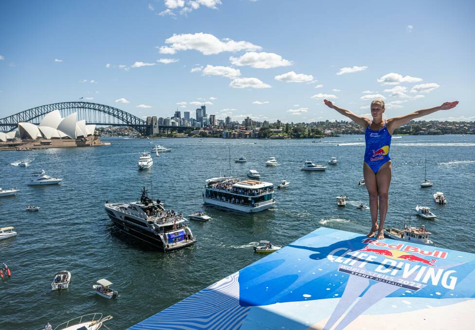 World champion Rhiannan Iffland pauses on the platform before launching herself 20 metres into Sydney Harbour on Saturday. Picture by Romina Amato, Red Bull Content Pool