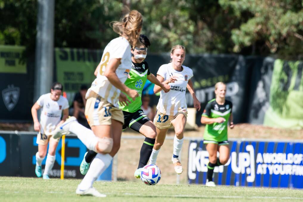 Canberra United's Chengshu Wu on the attack against Newcastle. Picture by Elesa Kurtz