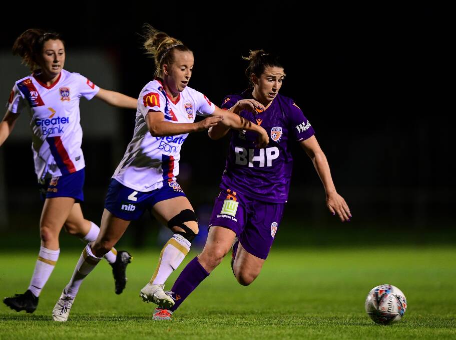 STRONG PERFORMANCE: Jets centre-back Hannah Brewer competes for the ball against Perth's Morgan Andrews at Dorrien Gardens on Saturday night: Picture: Getty Images