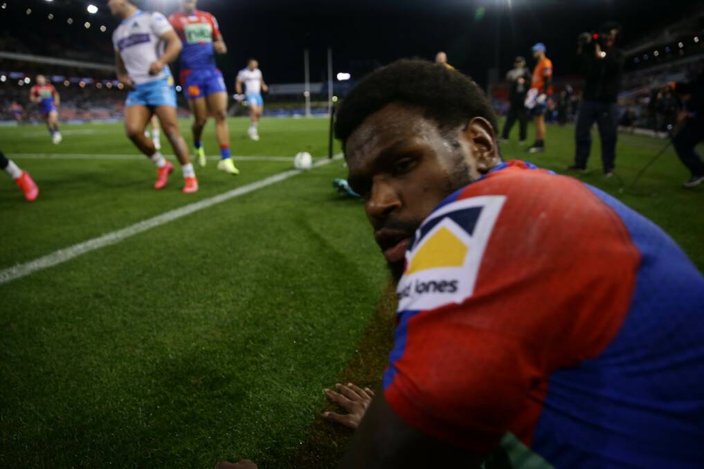 UP CLOSE AND PERSONAL: Knights winger Edrick Lee checks on Herald photographer Jono Carroll after collecting him while scoring the first of his club-record five tries against Gold Coast. Picture: Jonathan Carroll