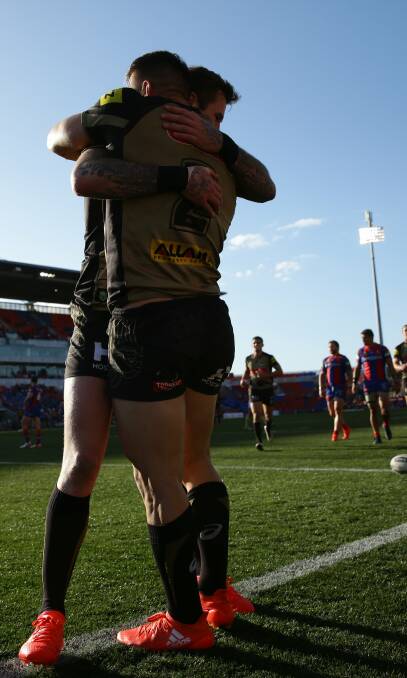 PENNIES FROM HEAVEN: Zac Hardaker congratulates Josh Mansour after the winger's second try against Newcastle on Sunday. Picture: Jonathan Carroll