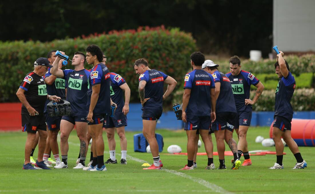 WORKING UP A SWEAT: Knights players re-hydrate during Thursday's session. Picture: Jonathan Carroll