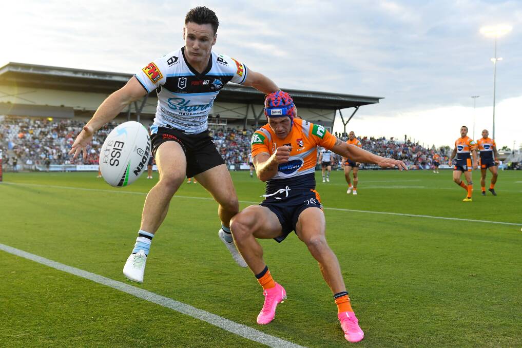 SCRAMBLE: Cronulla's Connor Treacy and Newcastle's Kalyn Ponga battle for the ball. Picture: Getty Images