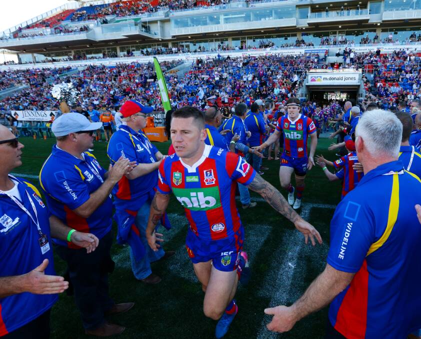 FLASHBACK: Shaun Kenny-Dowall runs out through the Old Boys' guard of honour before last year's clash with Cronulla. Picture: Jonathan Carroll