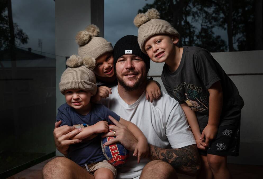 Newcastle Knight David Klemmer and his three boys, Cooper 7, Jaxon 5 and DJ 3, *CAN YOU DOUBLE CHECK AGES* in the new Mark Hughes Foundation beanies. Wednesday April 29, 2020. Photo by Marina Neil / NEWCASTLE HERALD / ACM