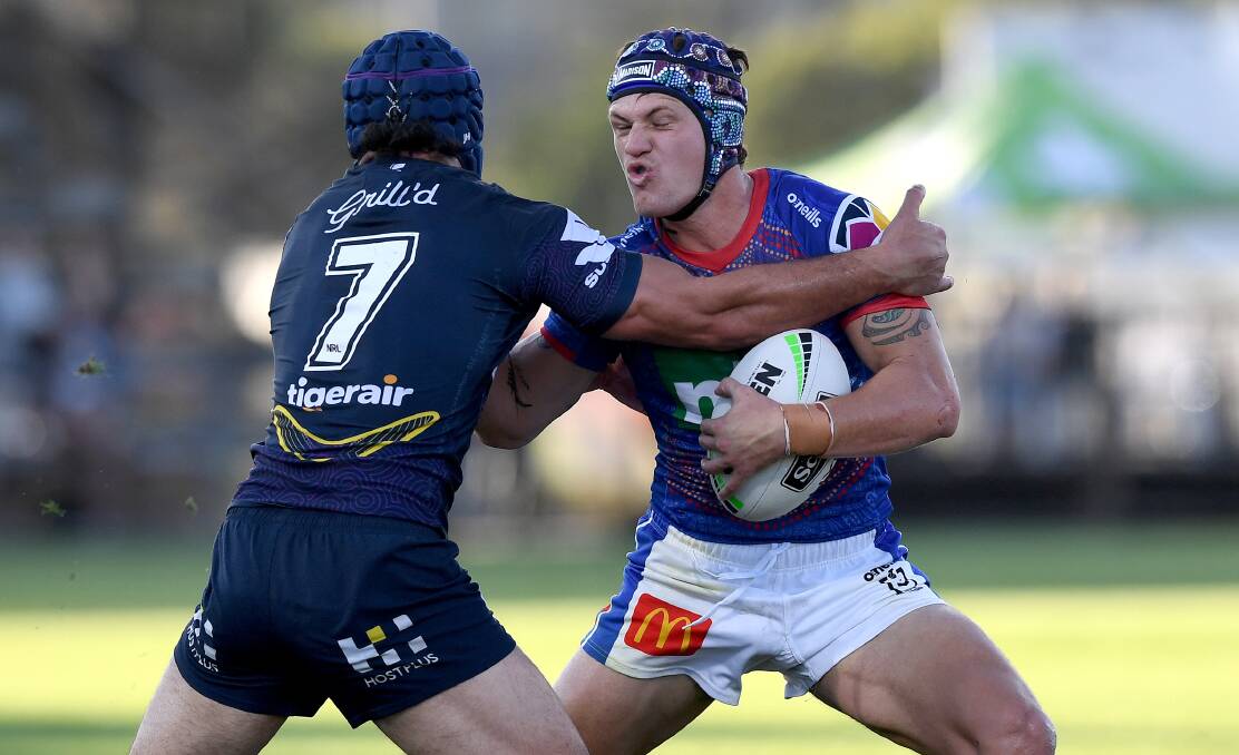 CRUNCH TIME: Jahrome Hughes tackles Kalyn Ponga. Picture: Getty Images