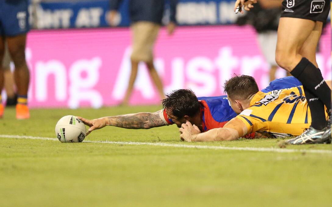 TRY TIME: Knights skipper Mitchell Pearce caps a man-of-the-match performance by stretching out to score against Parramatta on Sunday. Picture: Max Mason-Hubers